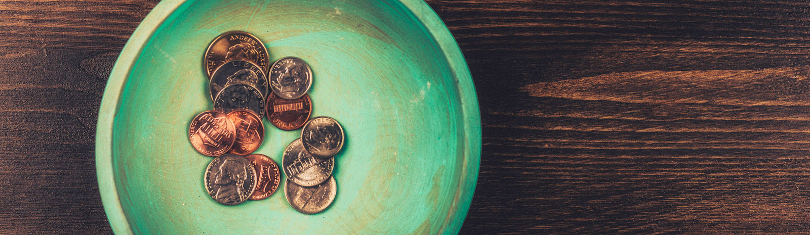 coins in a green saucer