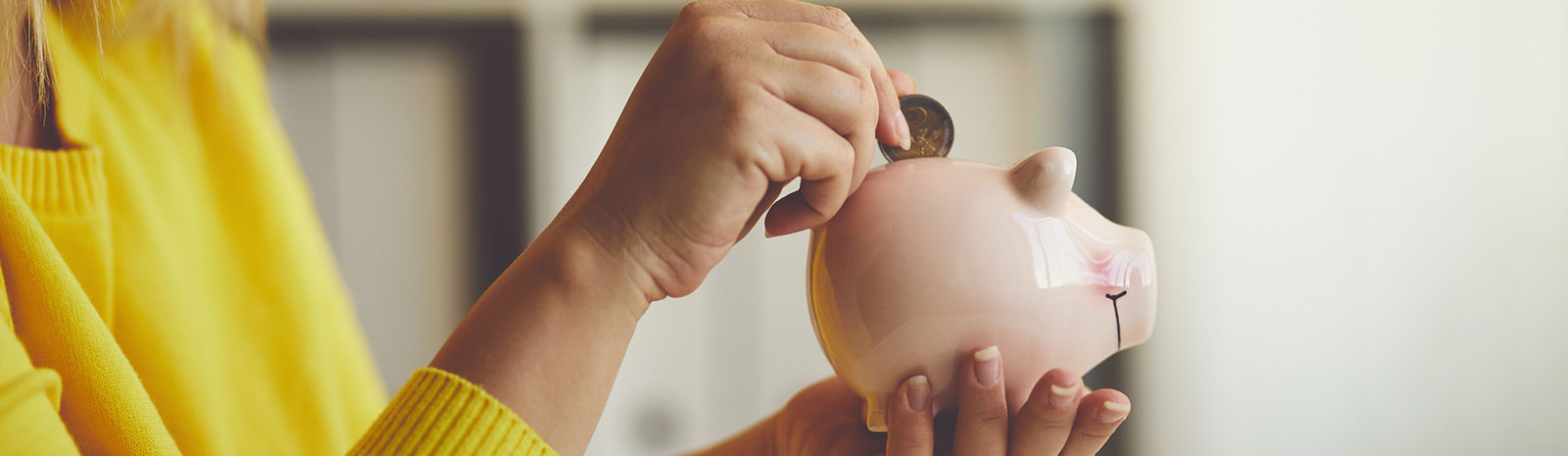 Lady saving money in a piggy bank