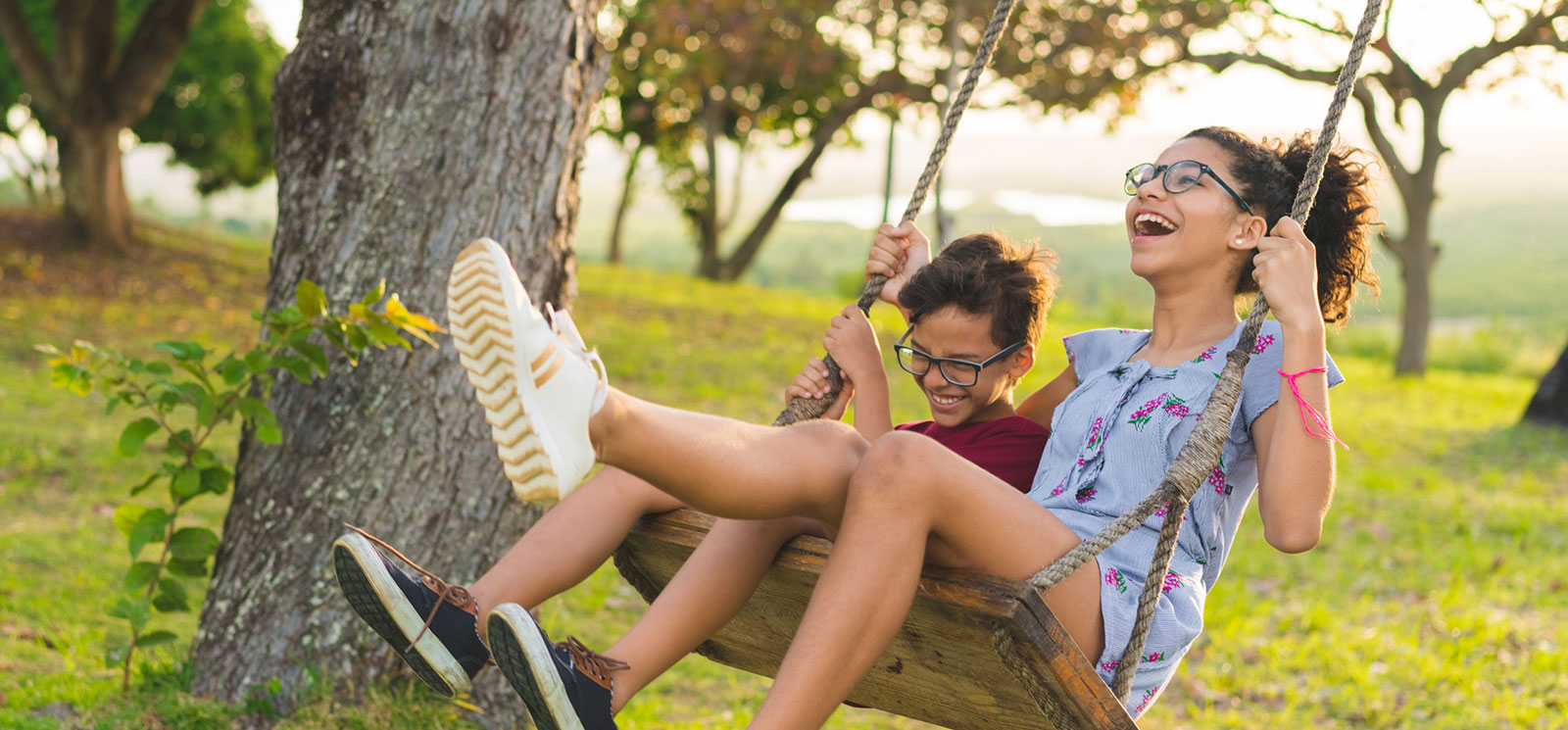 Kids laughing swinging in a swing