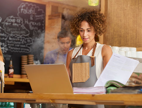 Lady going over financials in a restaurant