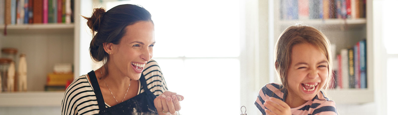 Mom and daughter playing in a kitchen