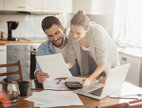 A couple looking at financials in their kitchen